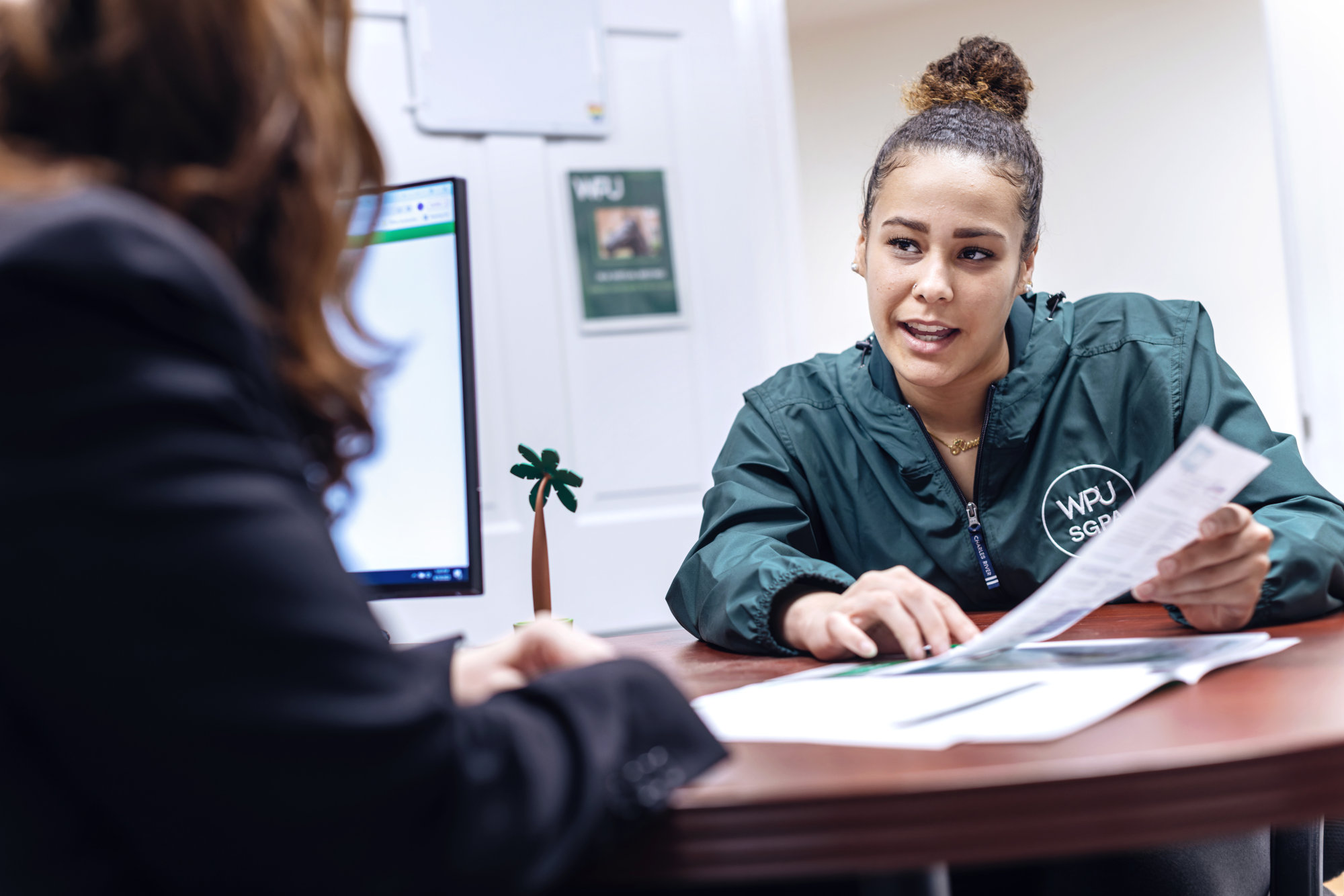 A student reviews scholarship and payment information in the financial aid office.