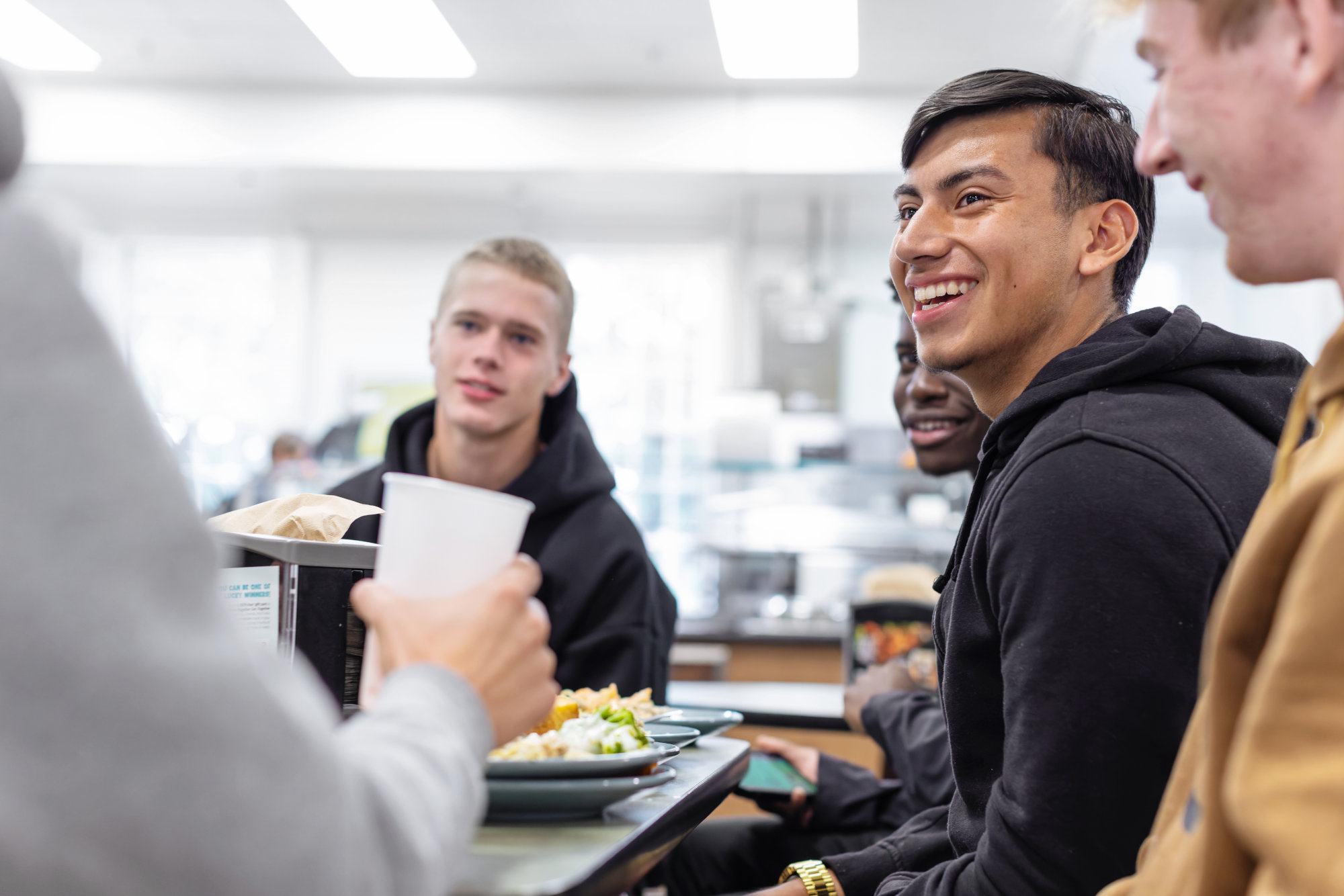 A WPU student sits with his friends while eating at Belk dining hall.