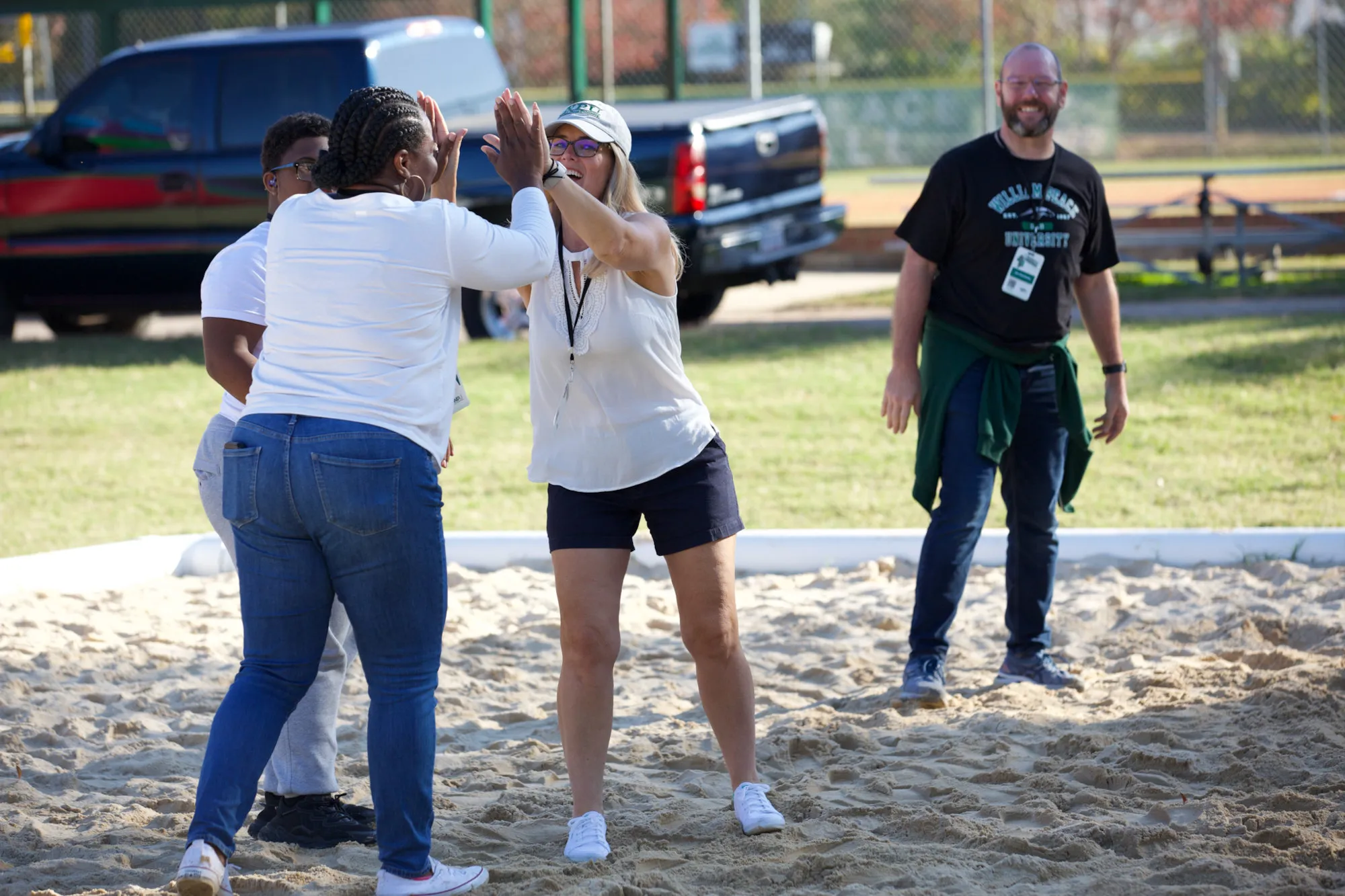 Students high-fiving each other